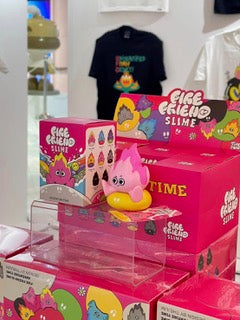 A group of pink blind boxes featuring Fire Friend Blind Box Series by The Jum Thailand, with a pink stuffed animal, a black shirt with a cartoon, and various toy characters.
