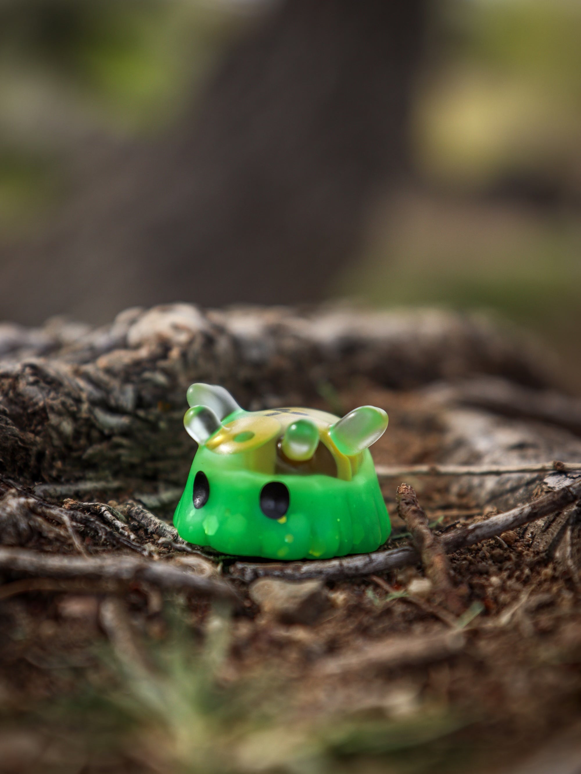 A whimsical green toy cube, like the Octopus Cube, from Fairies And Fancies' GRUBLETS collection at Strangecat Toys. Made of Polymer Clay and Resin.