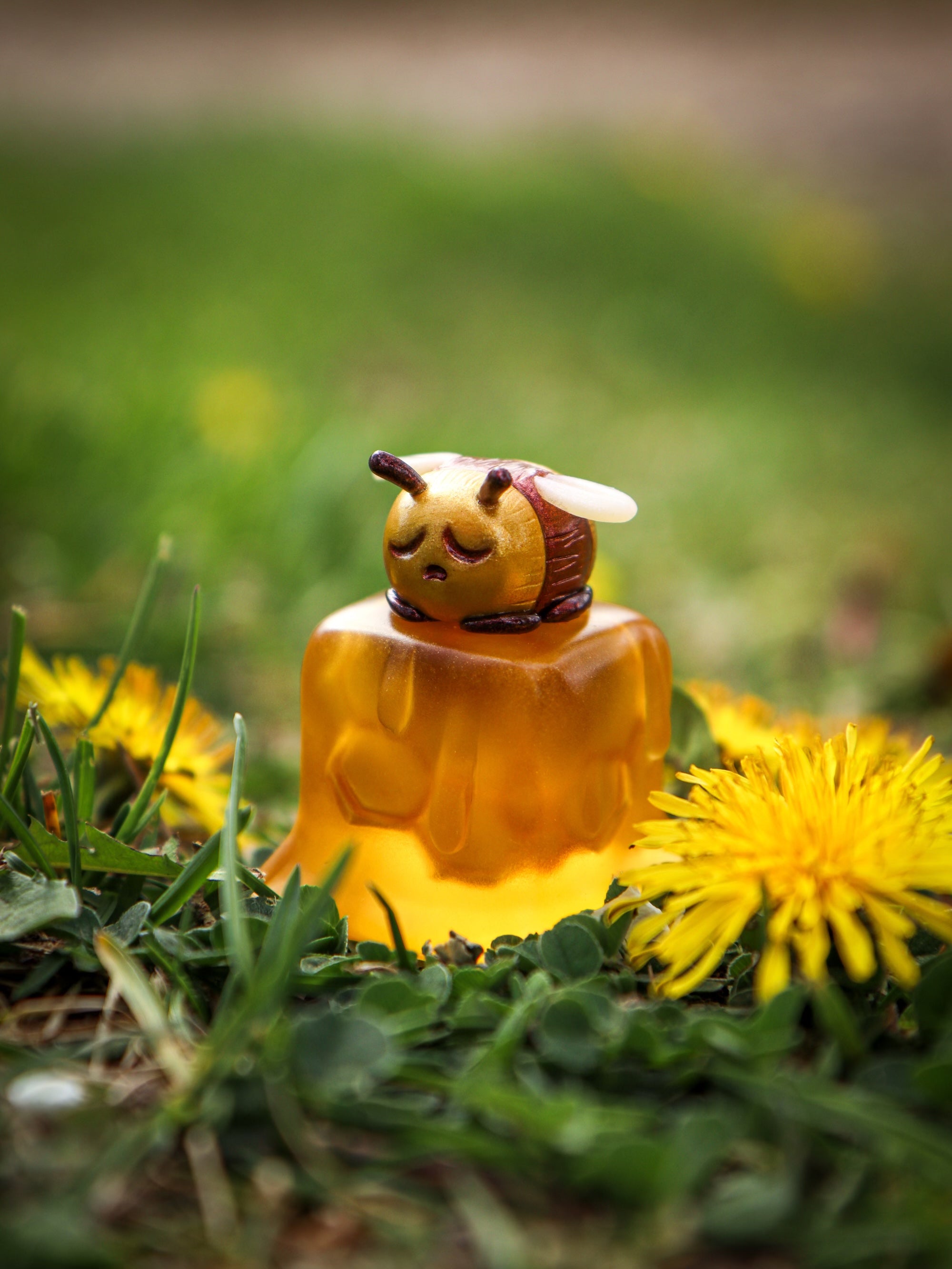 A bee on a yellow jelly cube with grass and flower details. Little Shit Big Deal - CUBES by Fairies And Fancies, sculpted by Dr. Polpz. Ships randomly.