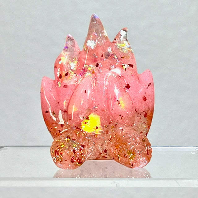 Translucent resin Ember figurine by Leecifer, featuring UV fluorescent pink gradient and rainbow beads. Limited edition, part of Little Shit Big Deal series.