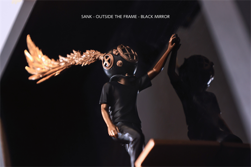 Sank - Outside the Frame sculpture featuring a child-sized figure with a vintage diving helmet and gold plume, posed against a reflective surface. Preorder, ships by Q4 2025.
