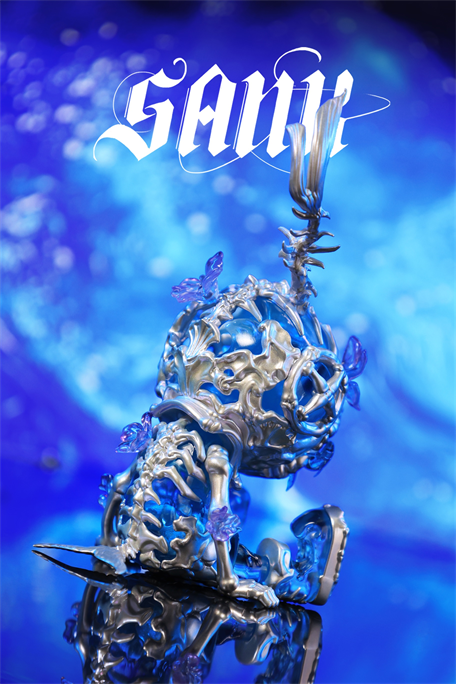 Sank Good Night Series-Whale Bloom: A futuristic, silvery humanoid sculpture with crystalline accents, seated with a book. Limited edition art piece, 8.3x8.7x15.5cm.