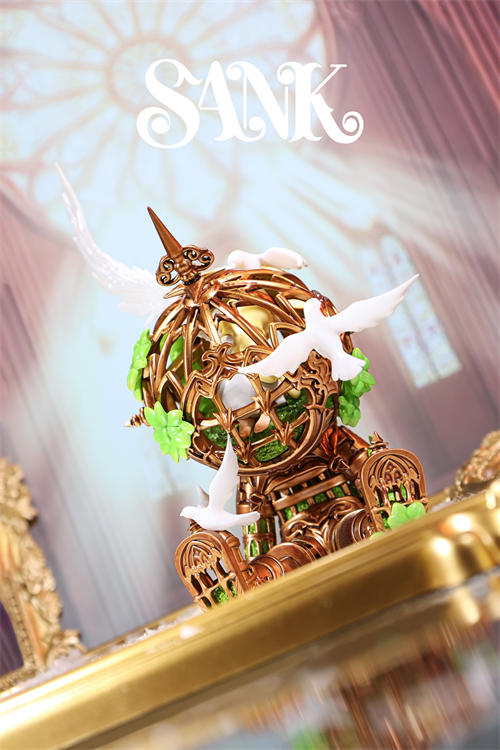 Good Night Series - Sky Wing: An ornate diorama featuring a golden filigree orb with white doves, accented with green leaves, set atop a polished surface.