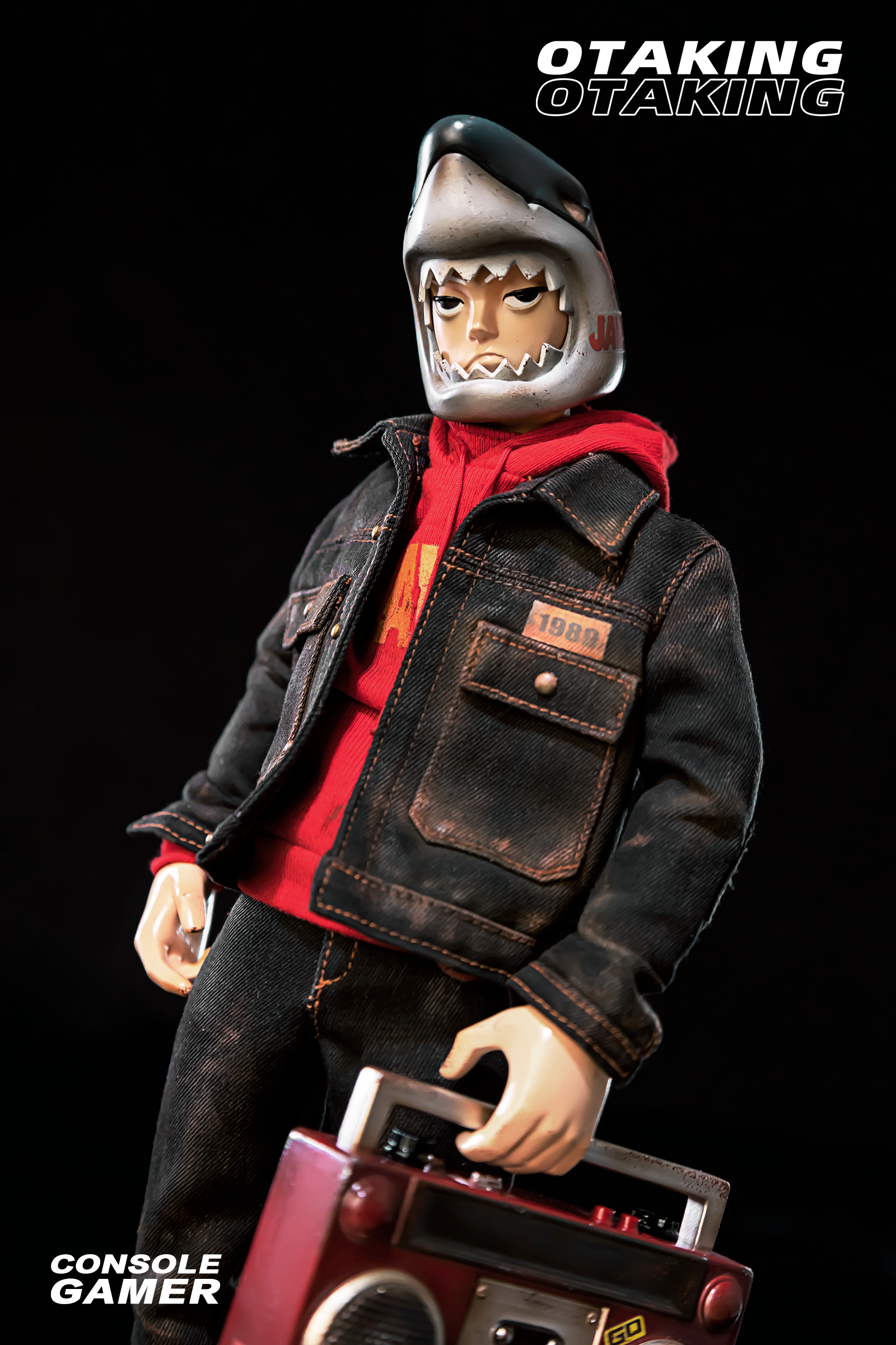 A toy doll in a red shirt and helmet, part of OTAKING - Console Gamer set with various accessories.