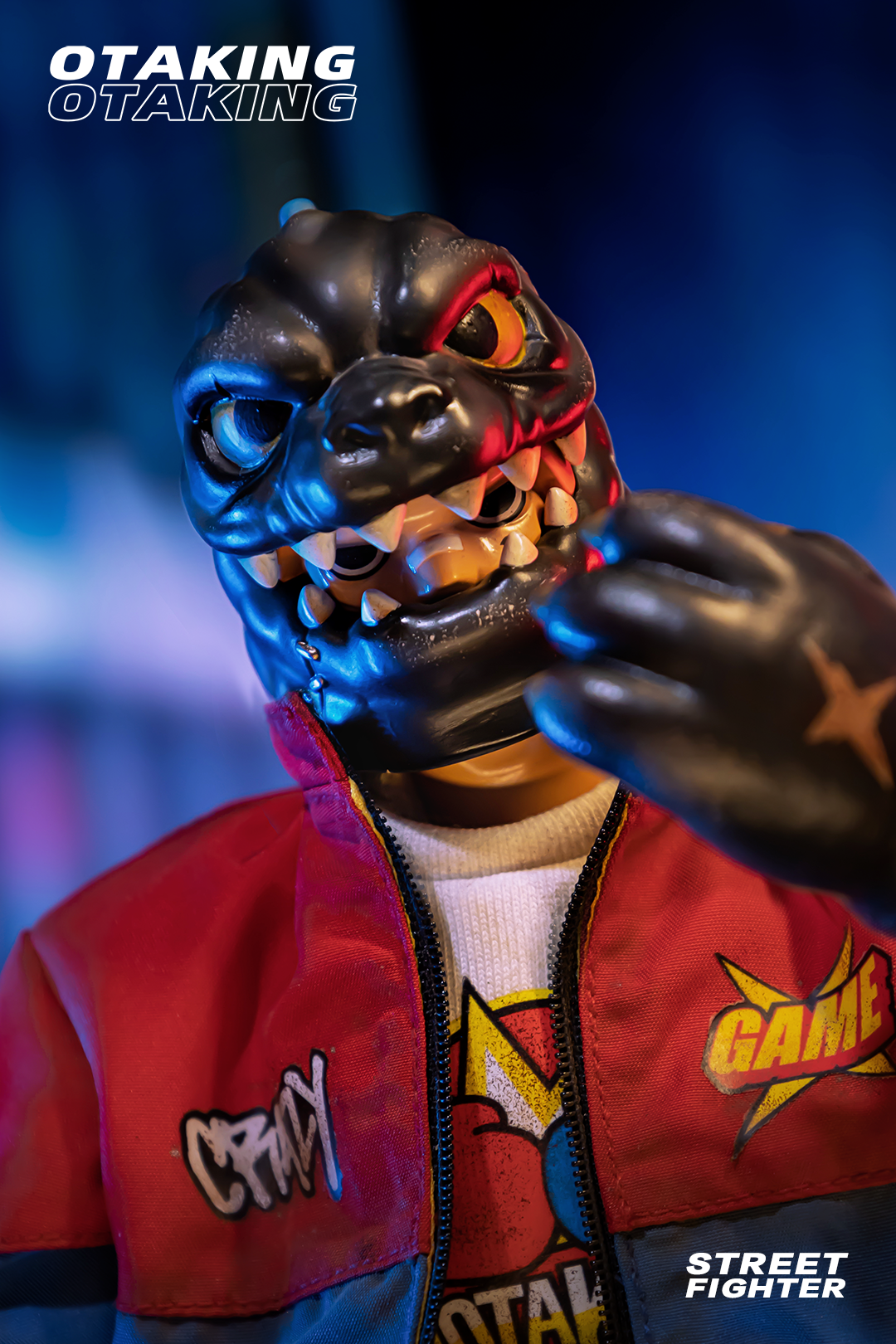 Toy figure in red jacket and black mask, close-up of logo and zipper, OTAKING - Street fighter.