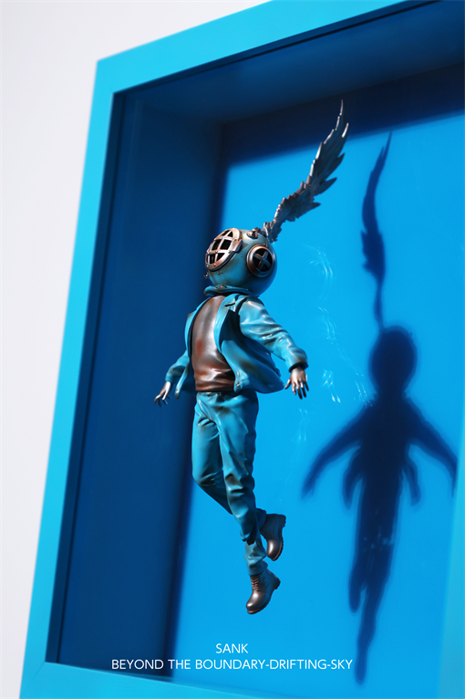 3D art piece Sank-Beyond the Boundary-Drifting-Sky features a diver figure in casual wear, floating in a blue display box.