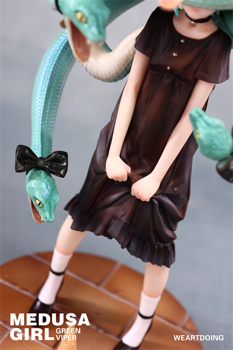 Medusa Girl-Green Viper figurine with teal snake hair and dark dress, on a brick-patterned base; a blend of fairy-tale whimsy and quiet tension.
