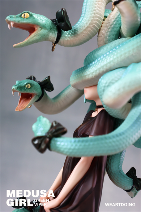 Medusa Girl-Green Viper collectible sculpture with mint-green snake hair, dark dress, and choker; snakes adorned with black bows, two baring fangs.
