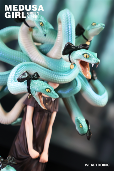 Medusa Girl-Green Viper figurine with snake hair, black bows, and gold earrings, in a dark dress. Limited edition resin sculpture by Yoshioka, pre-order available.