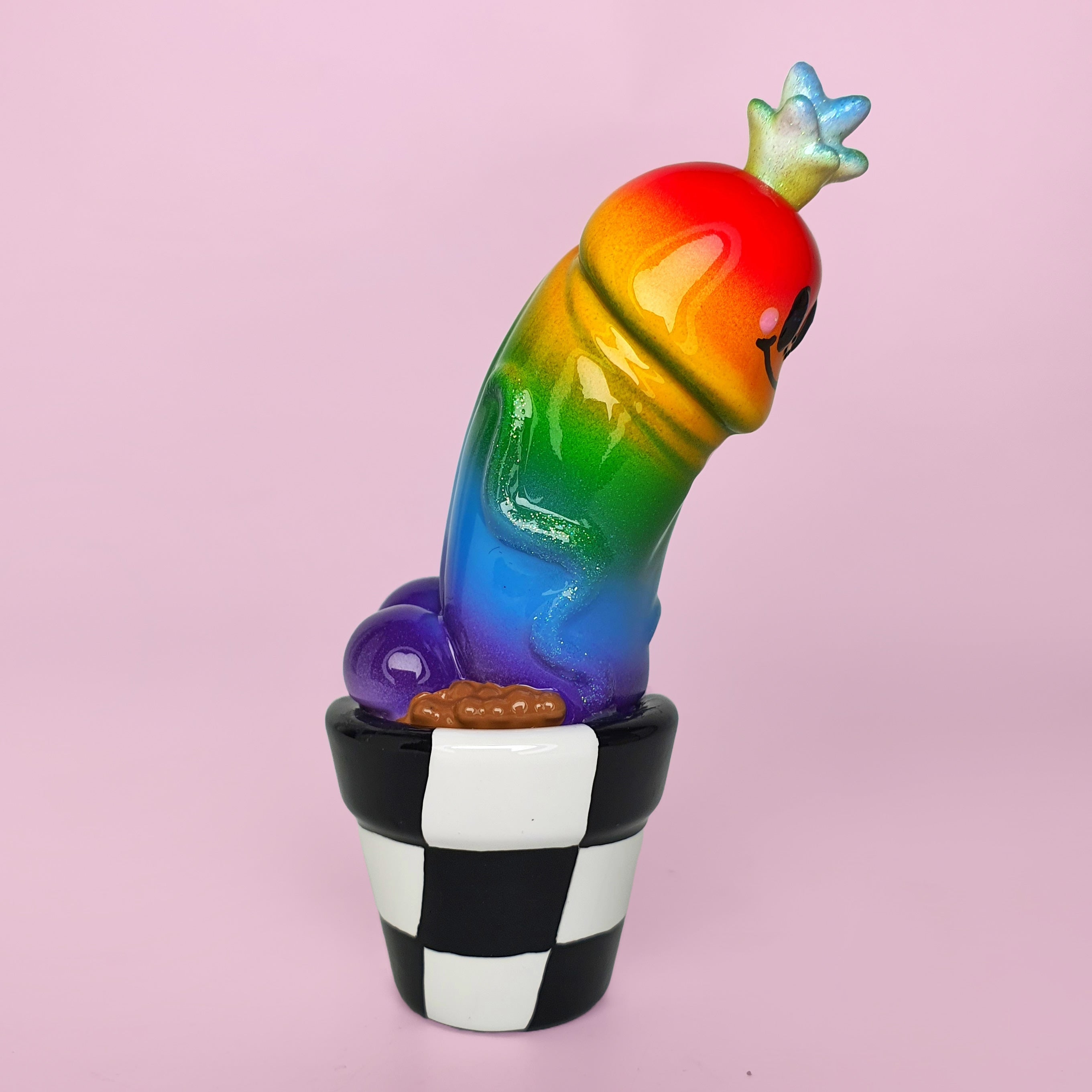 Simon Says Macy & Friends - Rainbow by Kik, a rainbow colored worm in a pot, a purple and black ice cream cup, a rainbow colored toy.