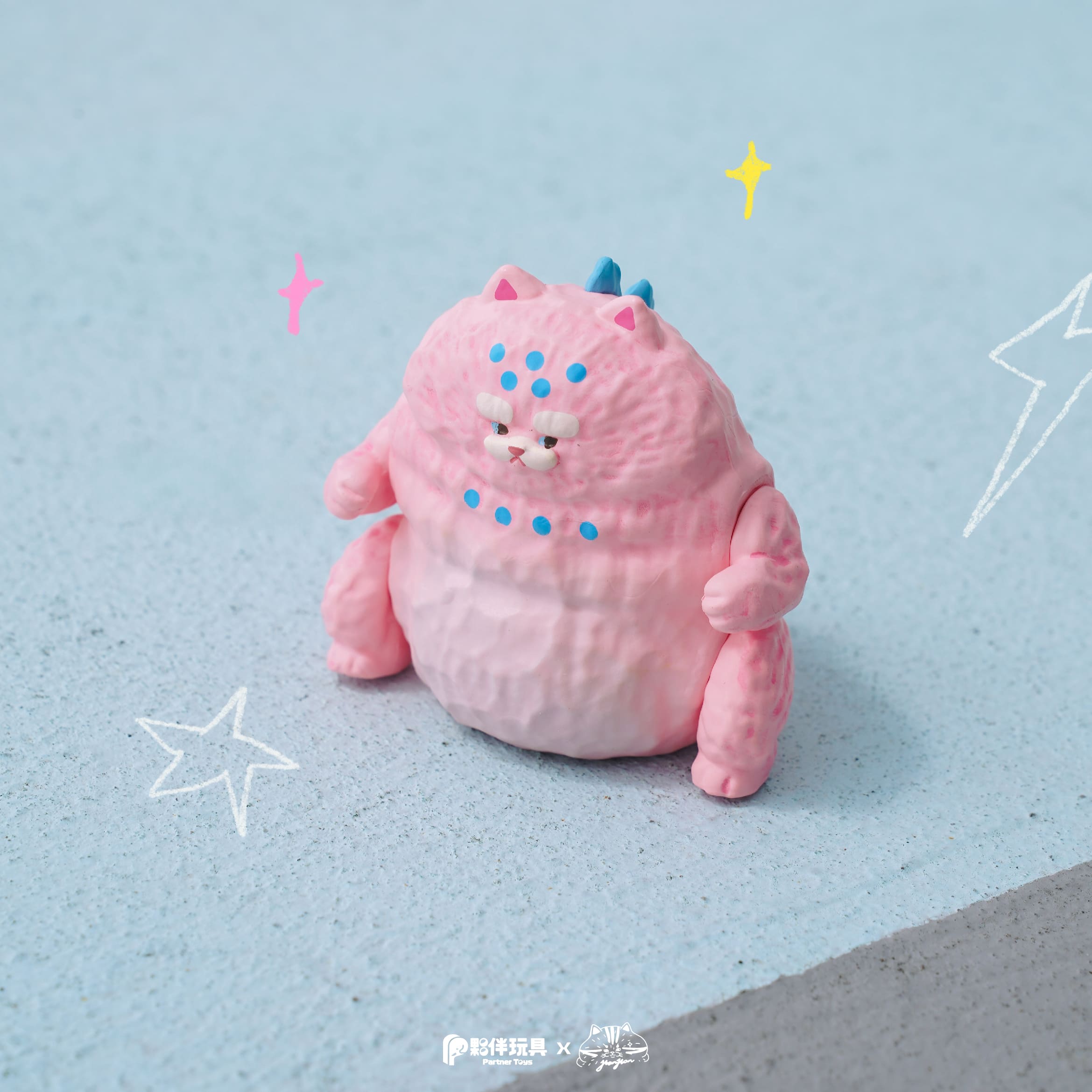 HanHanzoo - HanHan Dragon Blind Box figure, a pastel pink cat-like vinyl toy with blue spikes, sitting on a blue surface, available for preorder.