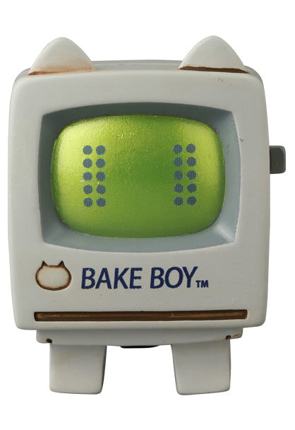 VAG Series 44 Baketan No. 2: a 2.5-inch vinyl toy with a green face, cat-head logo, and wind-up key, labeled BAKE BOY™.