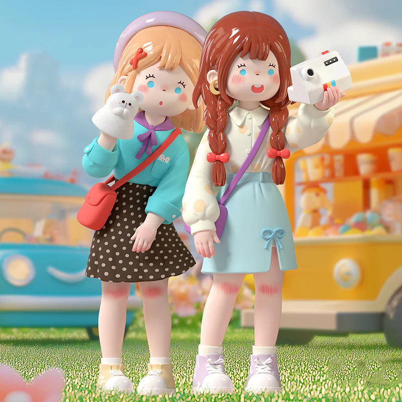 Suki-my friends series Blind box: two toy-like girl figures with playful accessories, featuring a bear puppet and camera, in a whimsical scene.