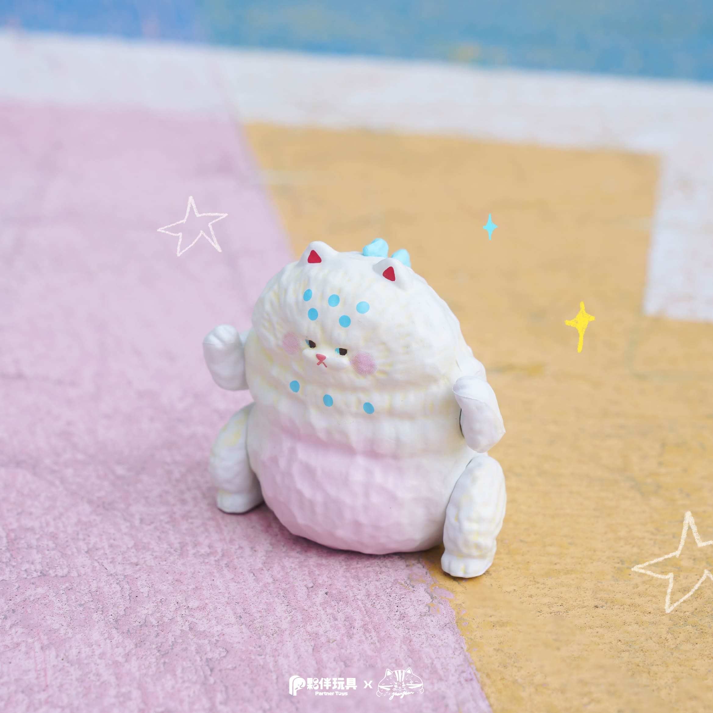 HanHanzoo - HanHan Dragon Blind Box: A chubby cat-creature figurine with pink hues, red ears, and blue dots, part of a collectible designer toy series.