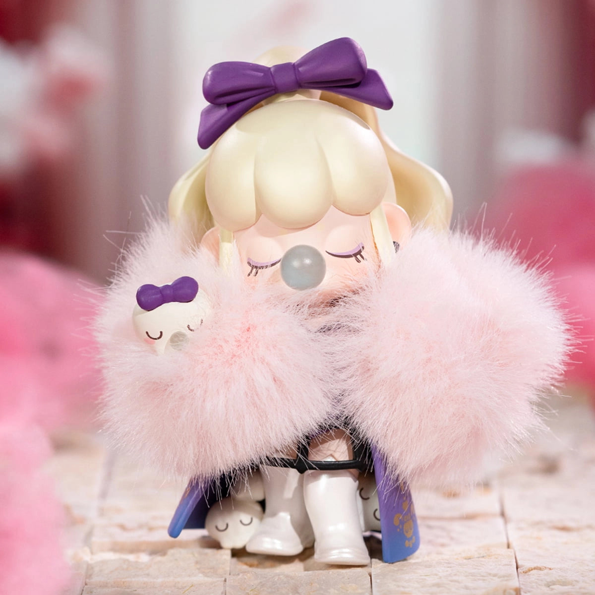 Nanci's Museum of Fantasy Blind Box Series: Stylized figure with bubblegum detail, ivory hair, purple bow, pink fur stole, hint of purple cape, white boots.