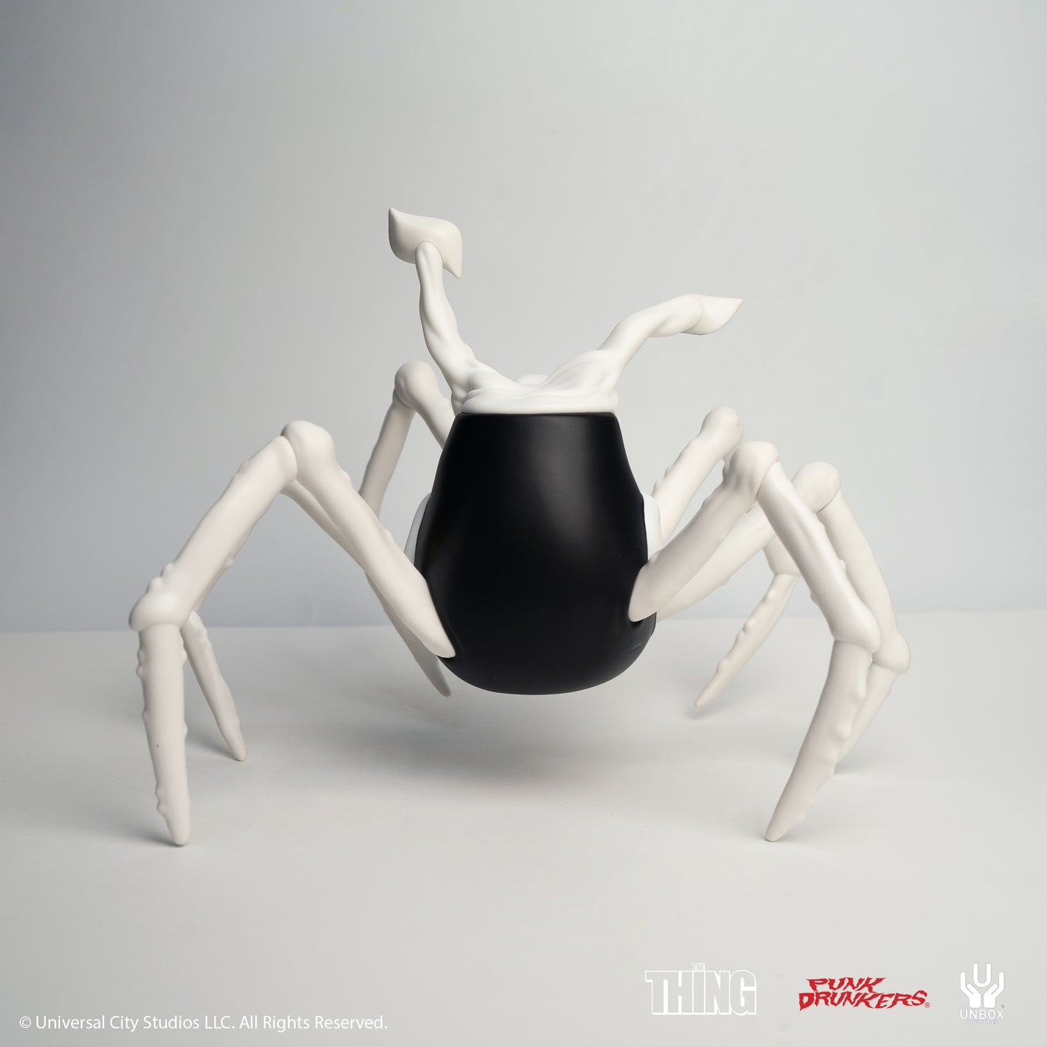 THE THING: PDS AITSU CHASE VARIANT HEAD - Preorder; a designer toy with matte-black body, bone-like legs, inspired by The Thing's spider-creature.