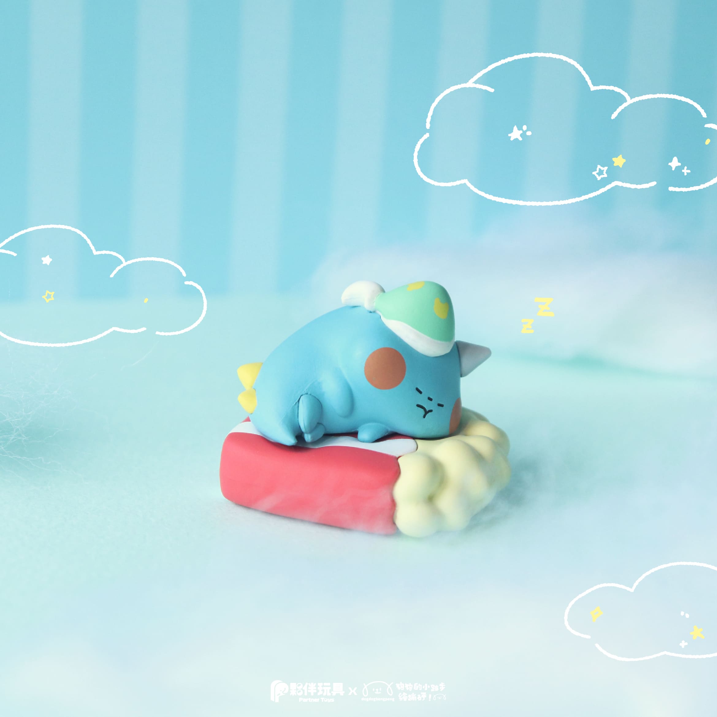Foodie Dino Snoozy Blind Box: A chubby, blue unicorn-dinosaur figurine asleep on a red cloud-like mattress, wearing a moon-patterned nightcap. Preorder now at Strangecat Toys.