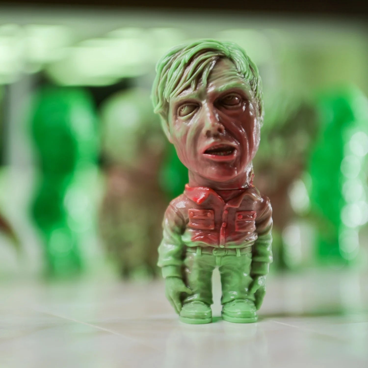 ZOMBI: DAWN OF THE DEAD Who Goes There Blind Box Series; green vinyl zombie figurine, oversized head, part of Unbox Industries' collectible art toy line.