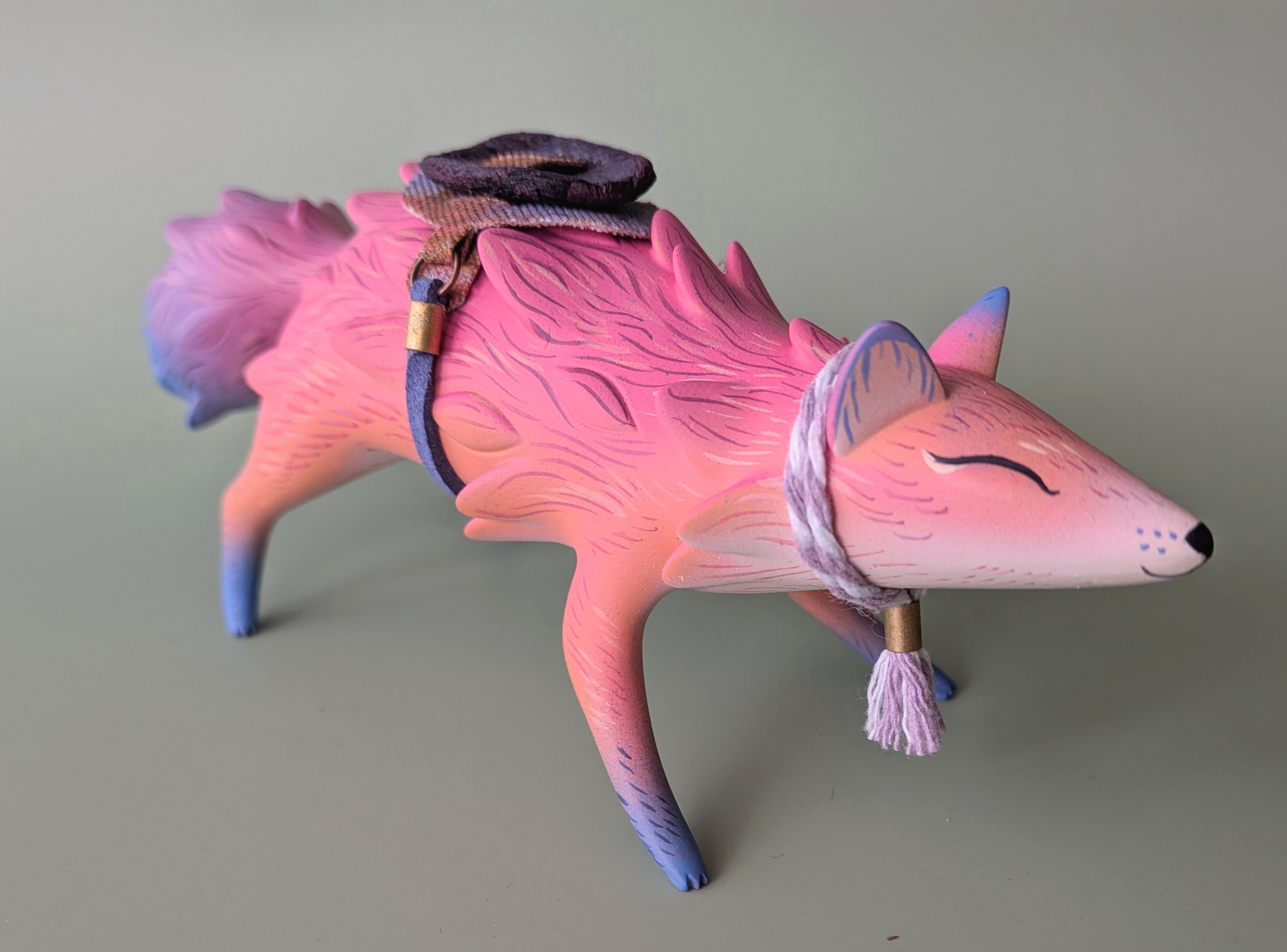 Small fox figurine in pastel tones with harness, created for ORACLE Group Show by Nimasprout x Faunwood, painted by Tomodachi Island, 10cm resin piece.