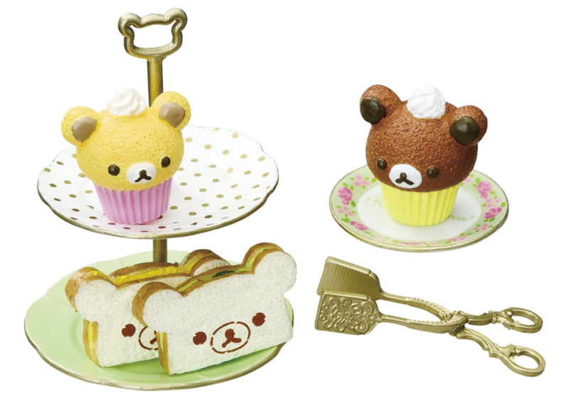 Rilakkuma Longing British Tea Time Re-ment Blind Box Series featuring bear-shaped cupcakes and cookies on a tray, part of a collectible toy series.