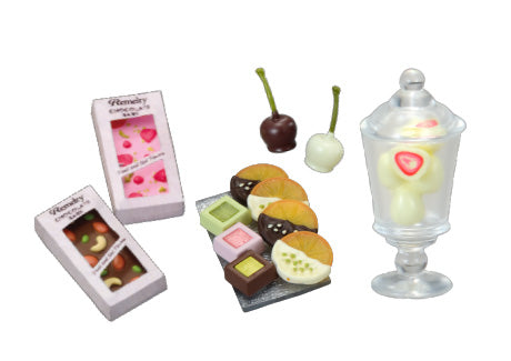 Chocolaterie Re-ment Blind Box Series featuring assorted fancy chocolates, chocolate-covered fruit candies, and white-chocolate lollipops with strawberry slices, showcasing all eight designs.
