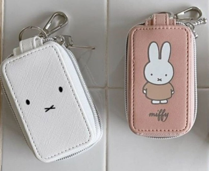 Miffy Key Case featuring a plain white and a pink/peach pouch with Miffy illustrations, both with a keyring and carabiner clip for easy attachment.