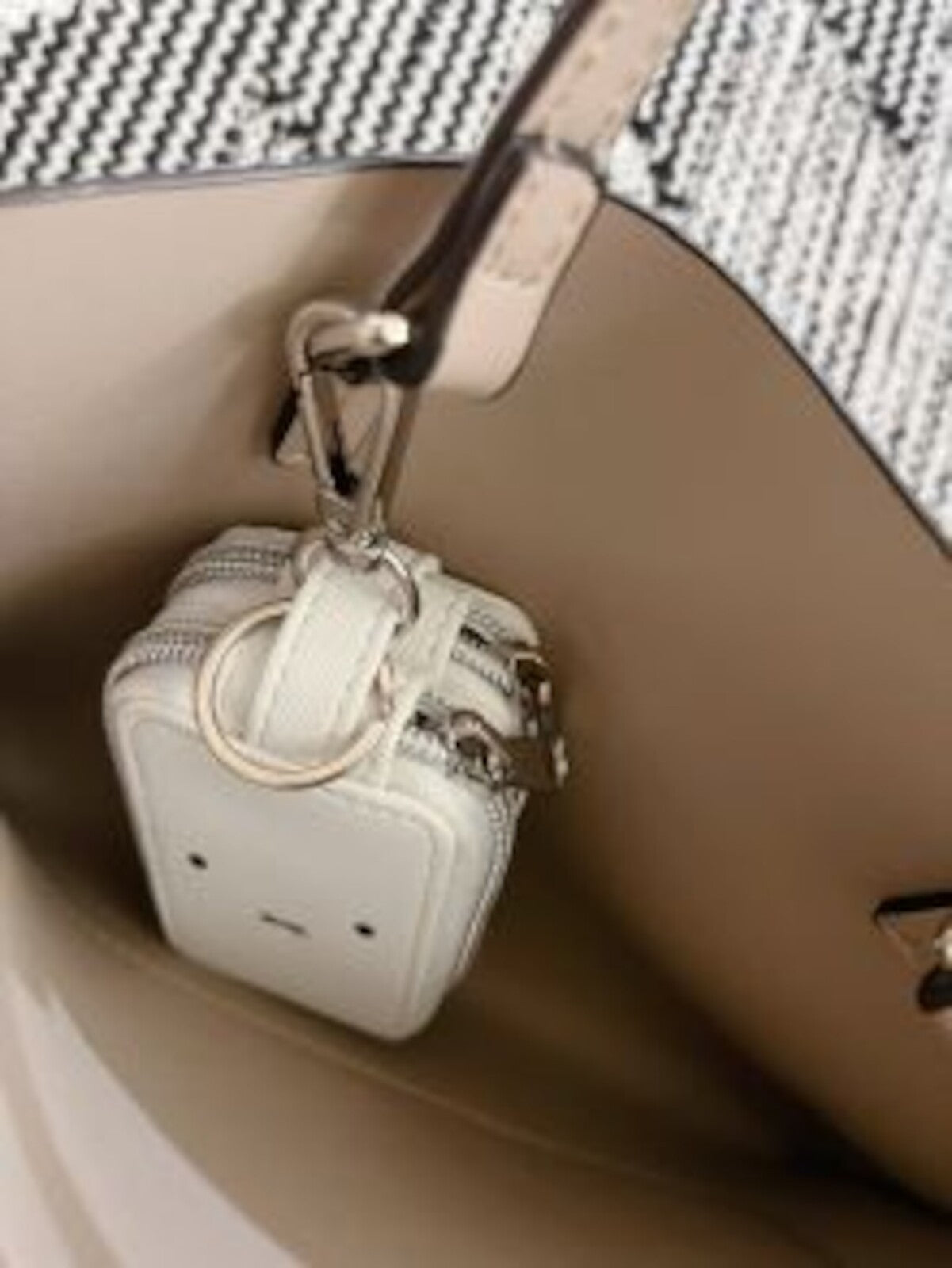 Miffy Key Case inside tote; off-white leather with two zippers, key-ring, and stamped face design, perfect for organizing keys and small essentials.