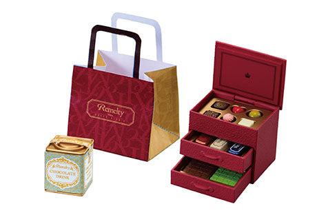 Chocolaterie Re-ment Blind Box Series features a decorative confection set: a red bag, pastel truffle box, and multi-drawer chocolate container.