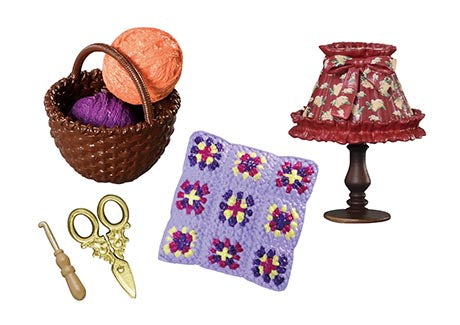 Grandma's sewing room Re-ment Blind Box Series featuring a crafting scene with yarn, scissors, a crochet needle, and a crocheted cushion under a decorative lampshade.