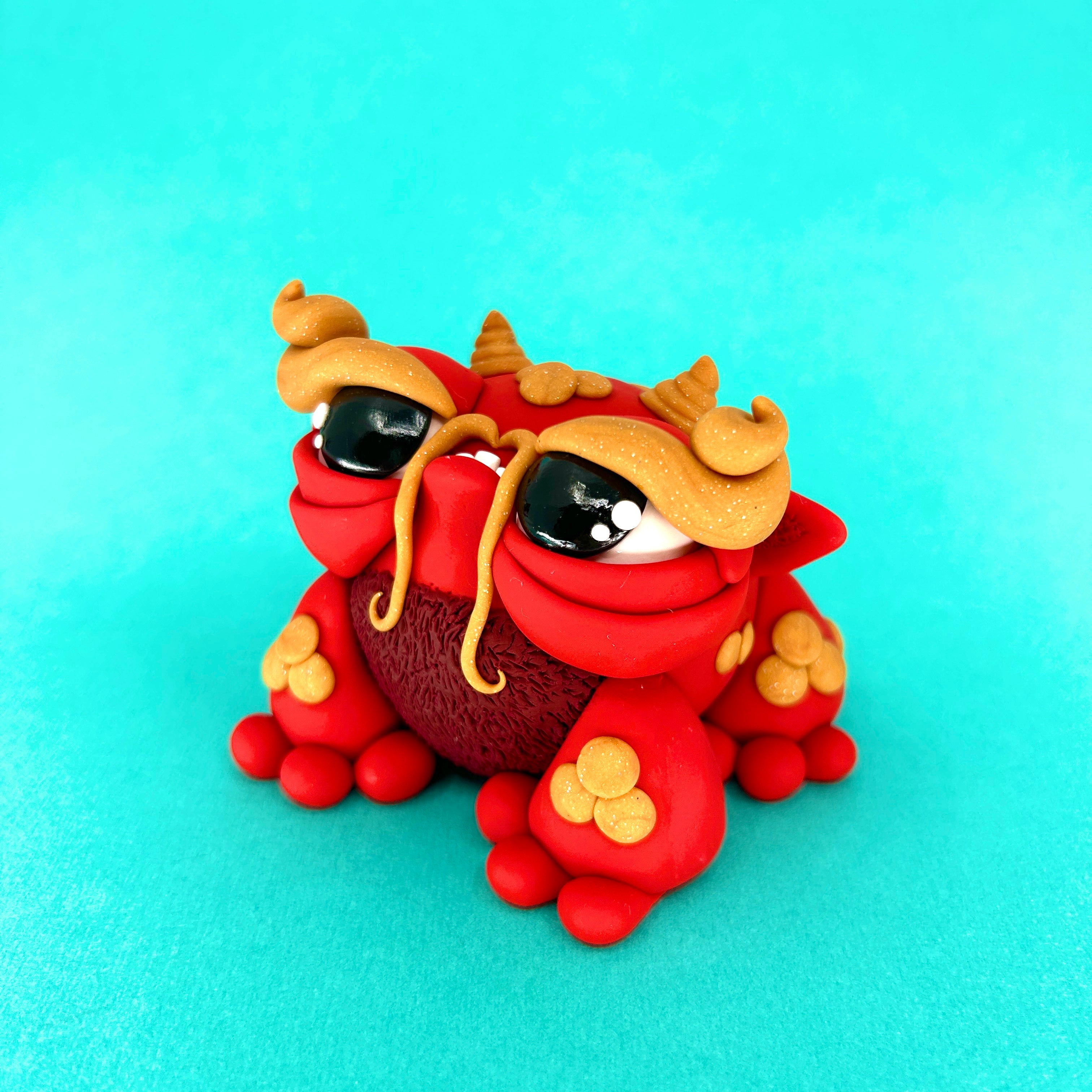 A polymer clay toy of Simon Says Macy & Friends - Mushu, an animal figure cartoon character.