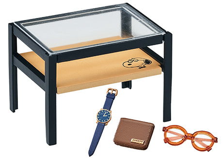 SNOOPY URBAN SELECT SHOP Re-ment Blind Box Series on a table with a blue watch and a brown wallet, showcasing collectible design variety.