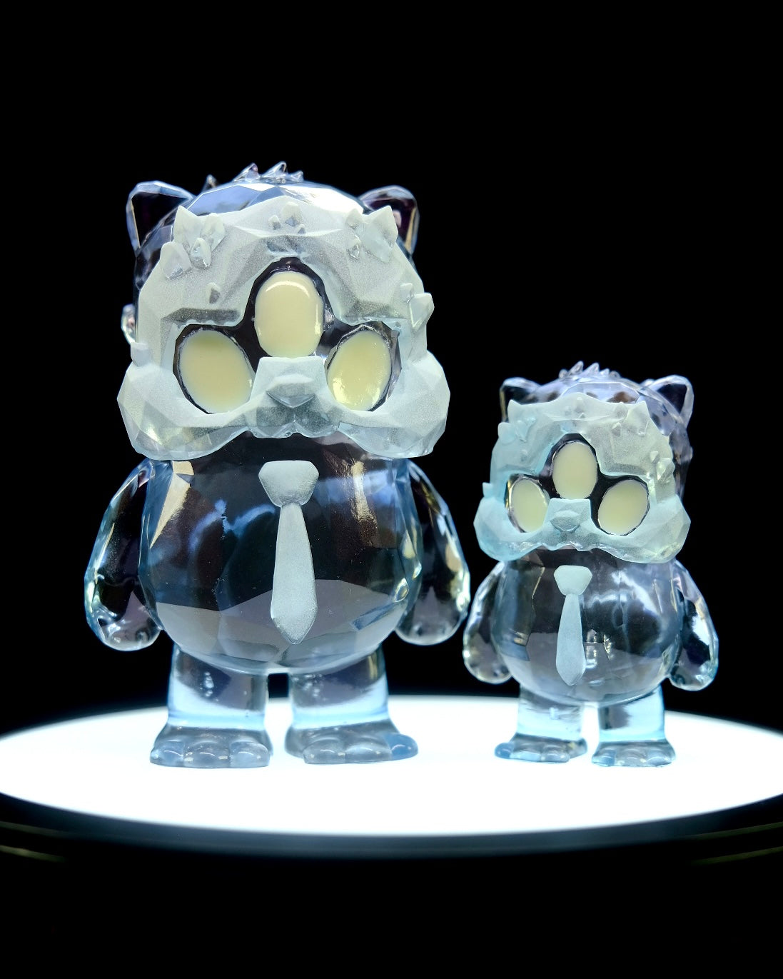 Beans Group Show - Arctic Beans by DTC Studios x Josh Divine features two resin figurines, a parent-child duo, on preorder, standing on a circular platform.