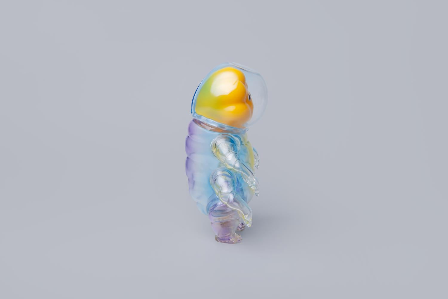 Water Bear - Diver by PPDAdventure: A translucent, rainbow-hued, glass-like figure inspired by tardigrades, featuring a flower-like face and clear helmet, 15 cm tall.