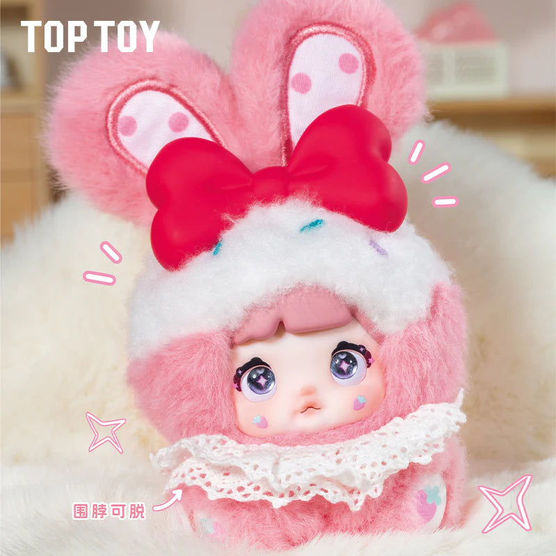 Nommi Baby Sweetheart Bunny Plush Blind Box toy in a fluffy pink bunny outfit with oversized anime eyes and a red bow, available for preorder.