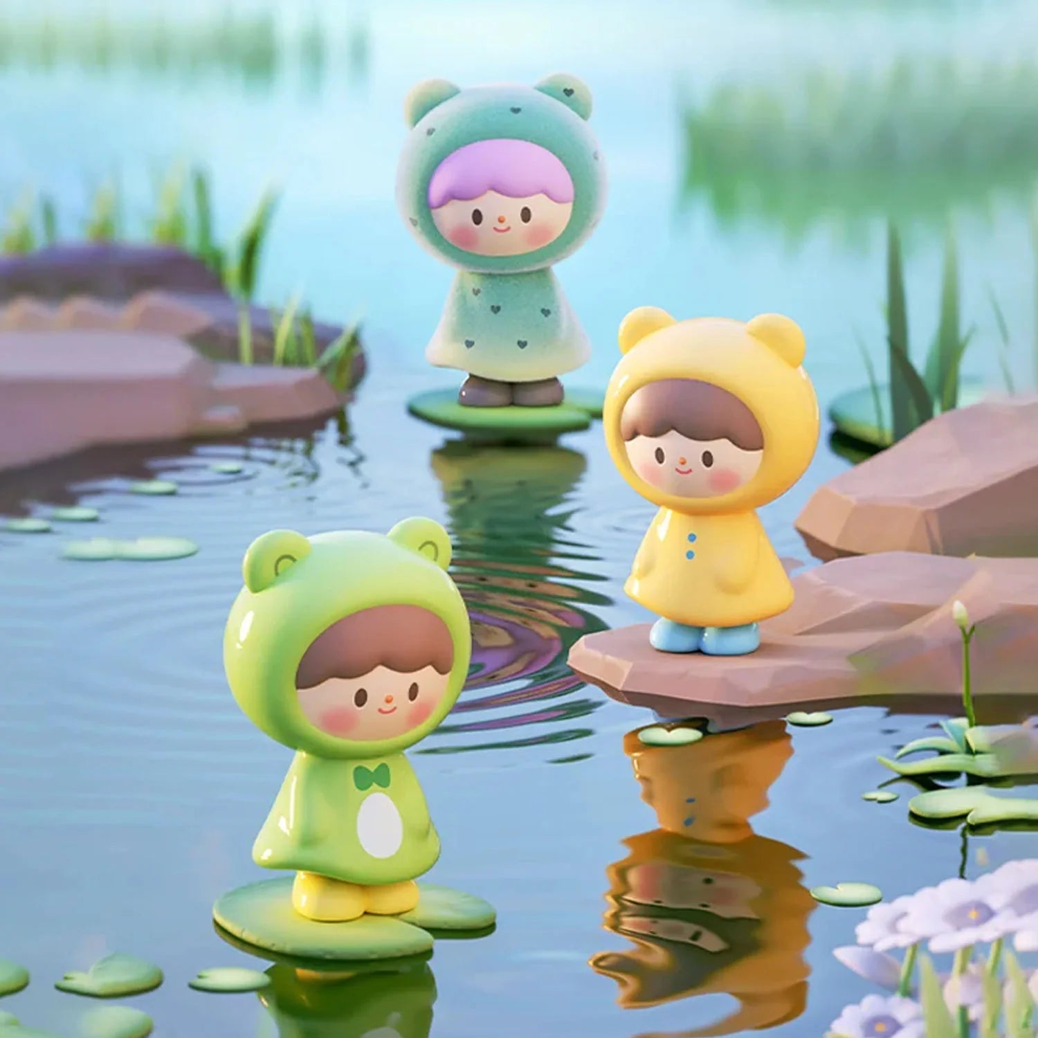 zZoton Joy In A Twist Uliuli Mini Series Blind Bag: Three stylized children figurines in animal-ear raincoats playfully balanced on lily pads and rocks in a whimsical pond scene.
