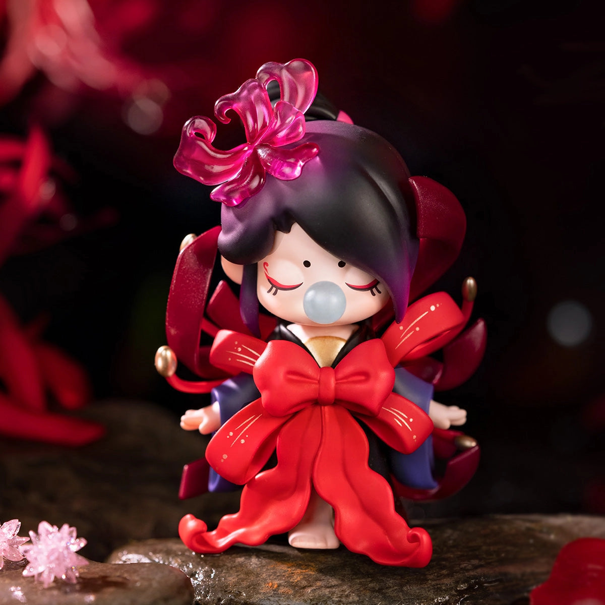 Nanci's Flower Stories Blind Box Series: Close-up of a toy figurine girl with a red bow, part of a 13-design collection.