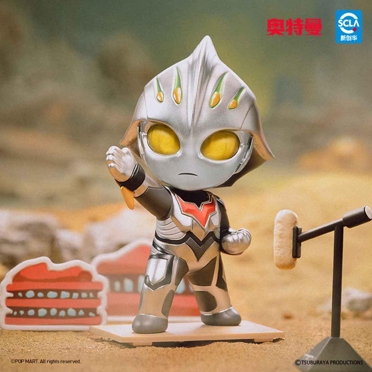 Ultraman Shooting Studio Series Figure: A chibi silver-and-black Ultraman with big yellow eyes on a base, posed speaking into a boom mic amid simple scenery props.