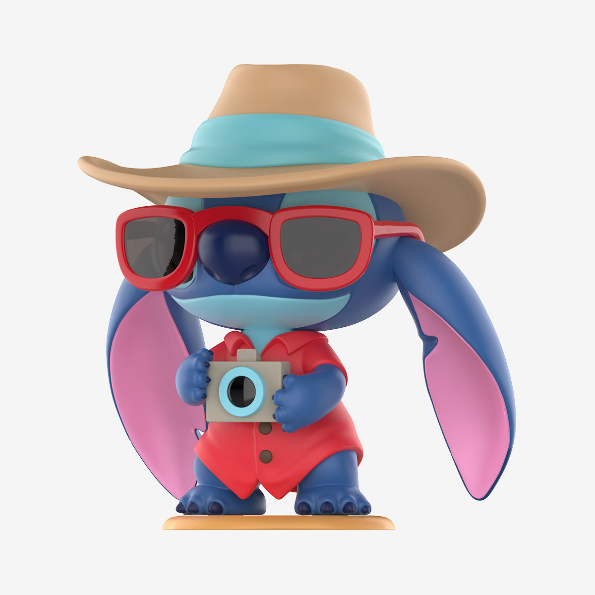 Disney Stitch on a Date Series Figure: a blue cartoon creature in tourist attire with a straw hat, sunglasses, and camera. Preorder for Strangecat Toys.