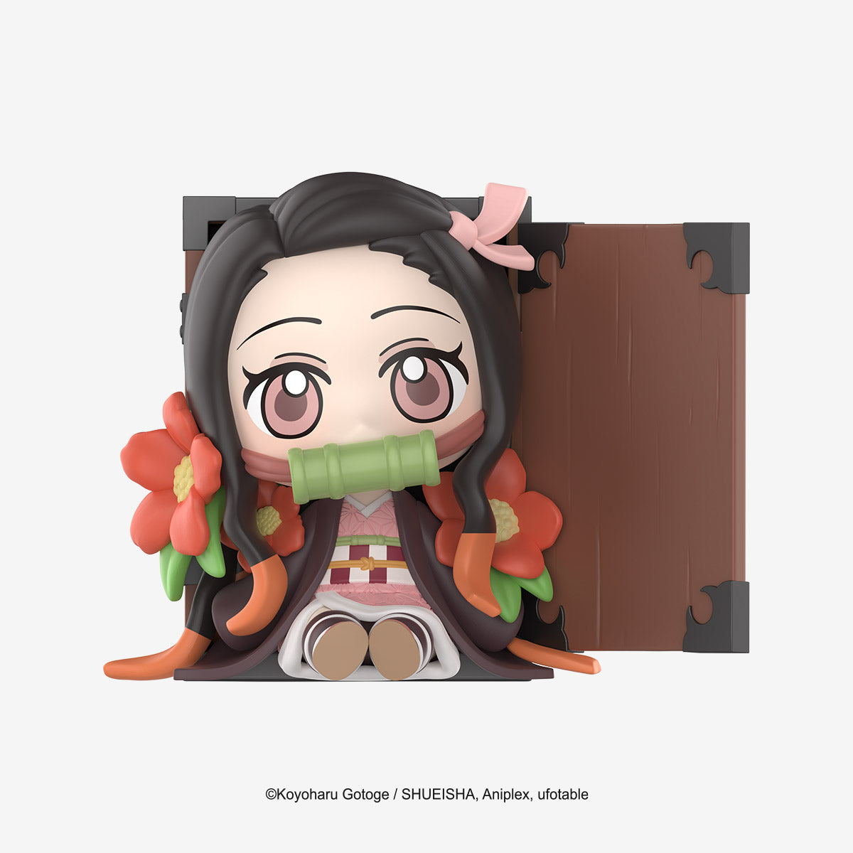 Chibi-style Nezuko Kamado figure from Demon Slayer: Kimetsu no Yaiba Birth Flower Series, seated in a wooden box with floral accents, official merchandise.