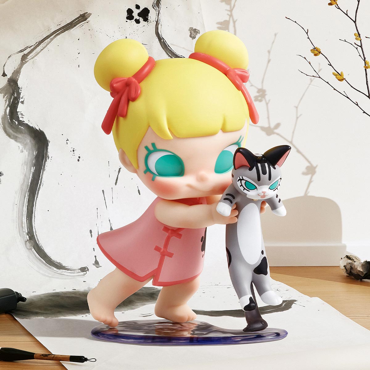Baby Molly & Baby Tabby Series Figure: A stylized girl with cat figurine, set against calligraphy tools and floral shadow backdrop.