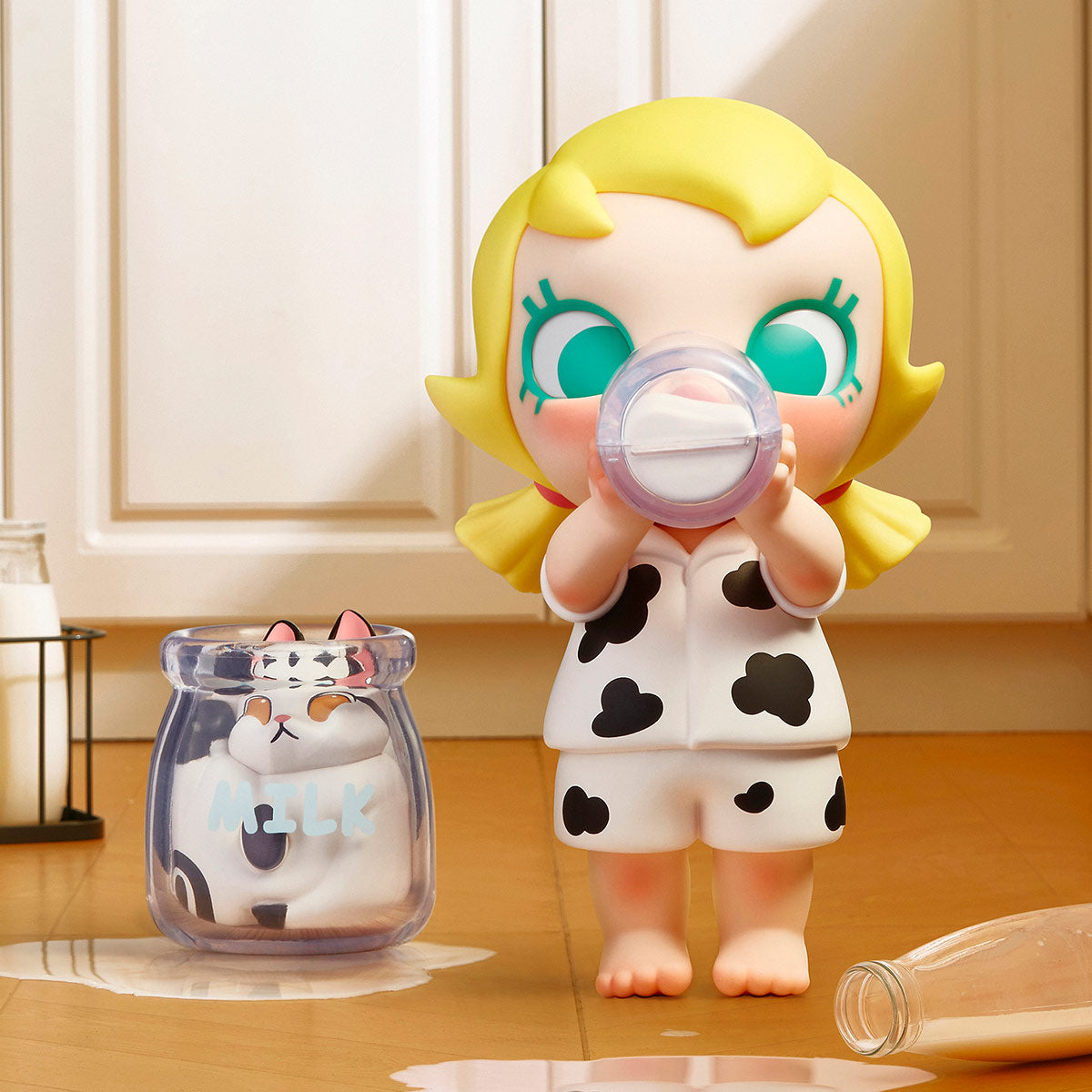 Baby Molly & Baby Tabby Series figure: a girl in cow-print pajamas with a milk bottle, a cat in a milk jar, part of a collectible set.