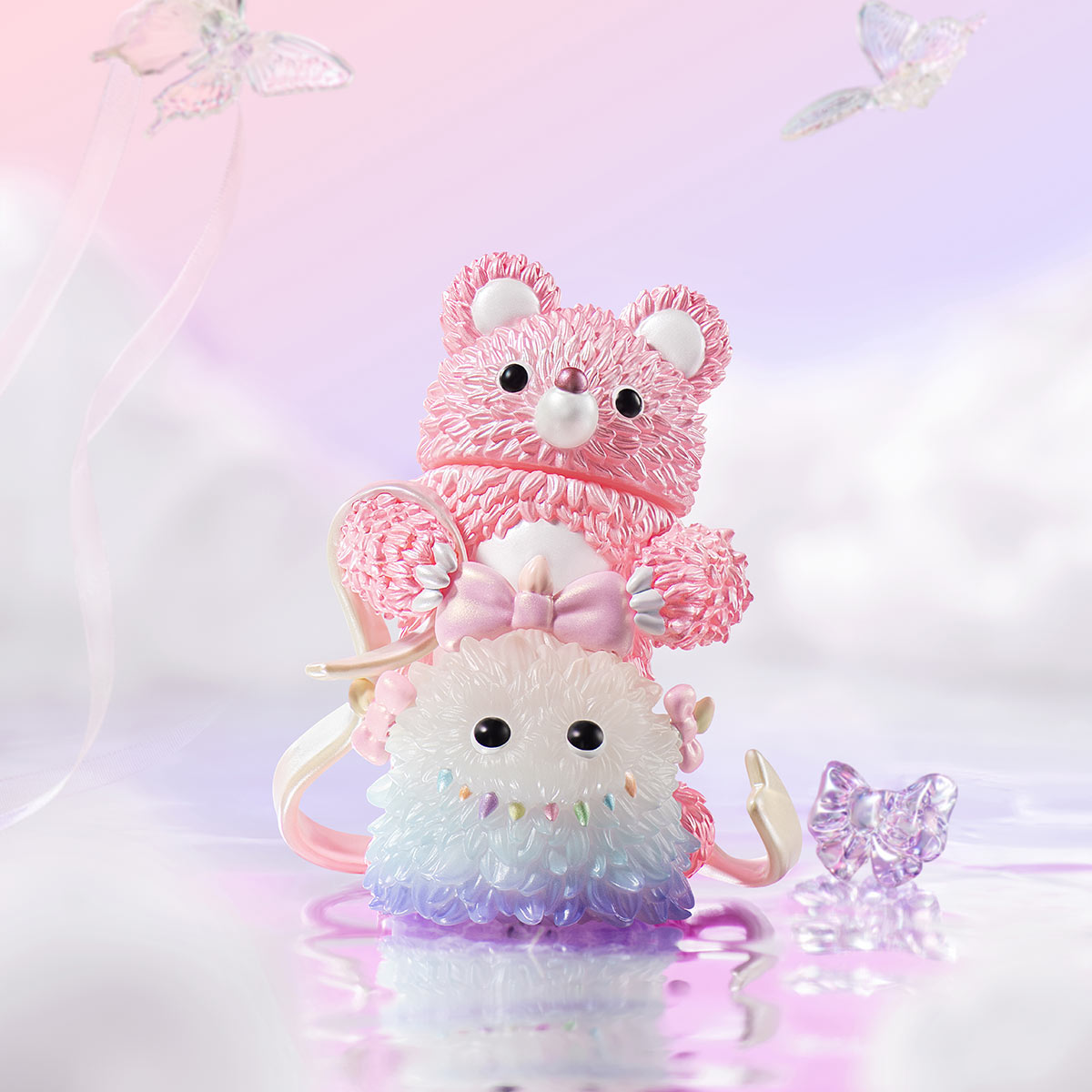INSTINCTOY Muckey Celebration gift Series: Stackable kawaii rings with a pink teddy bear, a fluffy creature, and a purple butterfly charm on a glossy surface.