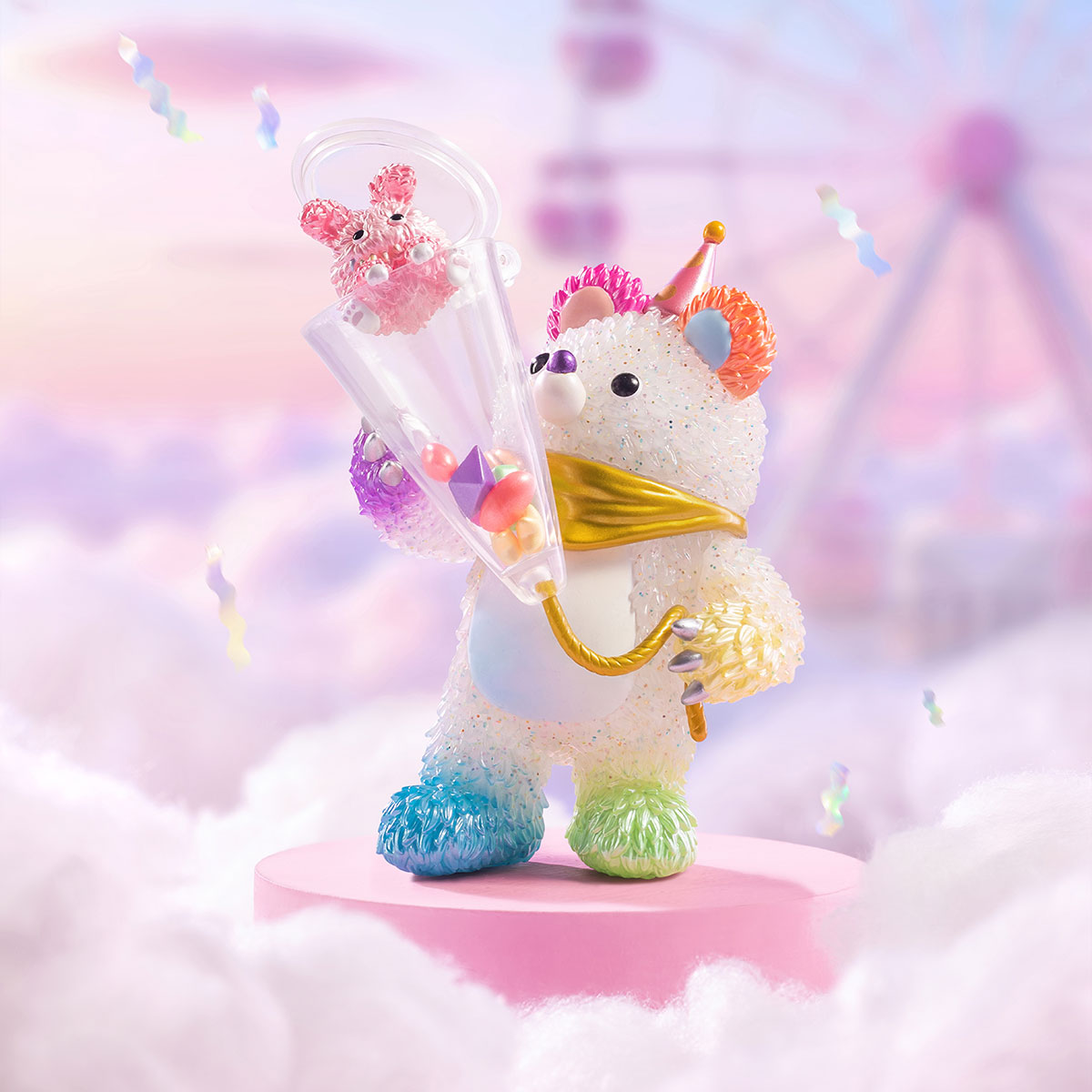 INSTINCTOY Muckey Celebration Series toy: a bead-textured bear with a party hat, gold scarf, holding a funnel with confetti, evoking a carnival atmosphere.