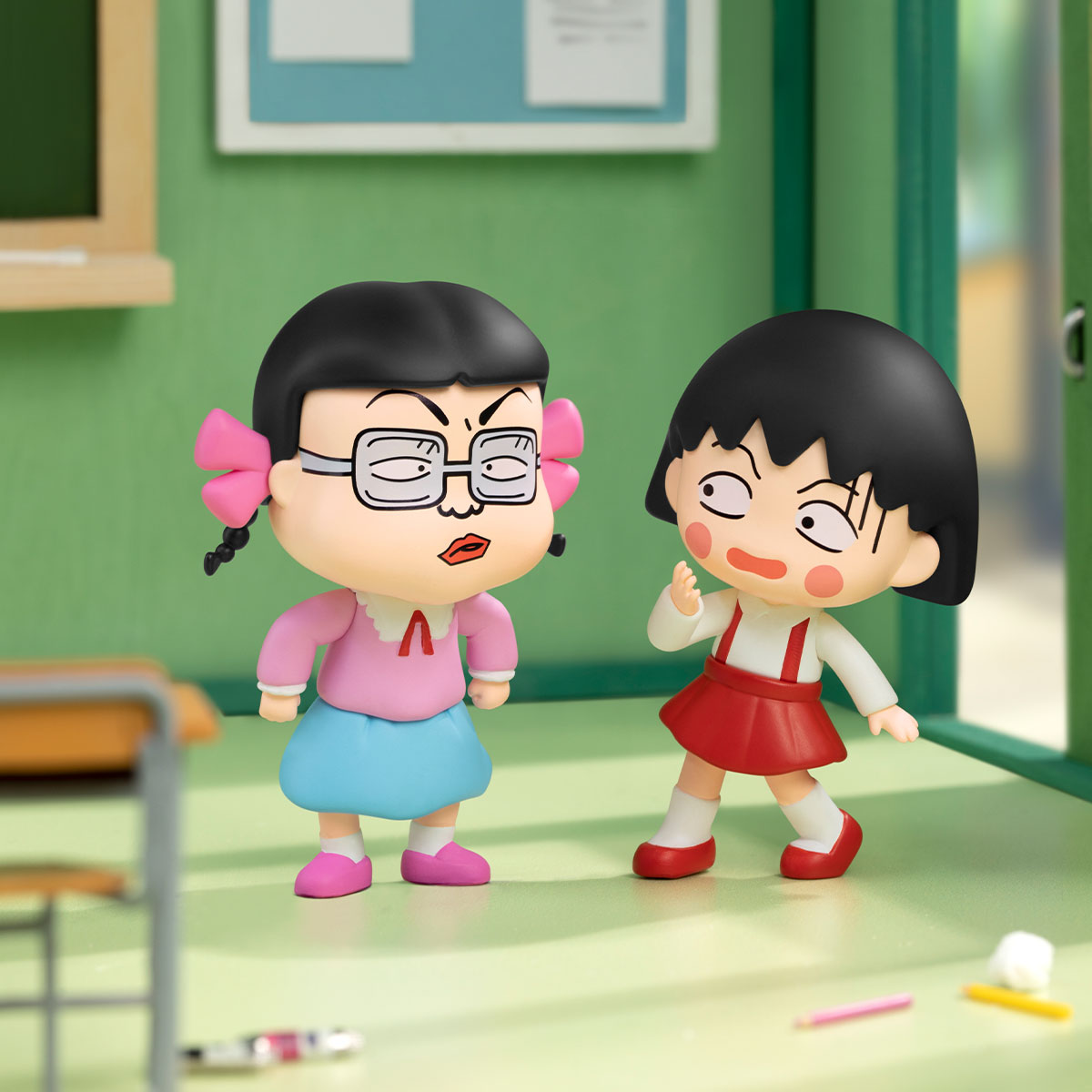 Chibi Maruko Chan's The Time With You Series Figures: two chibi schoolgirls in a classroom scene, featuring playful, cartoon-style designs. Part of a collectible toy series.