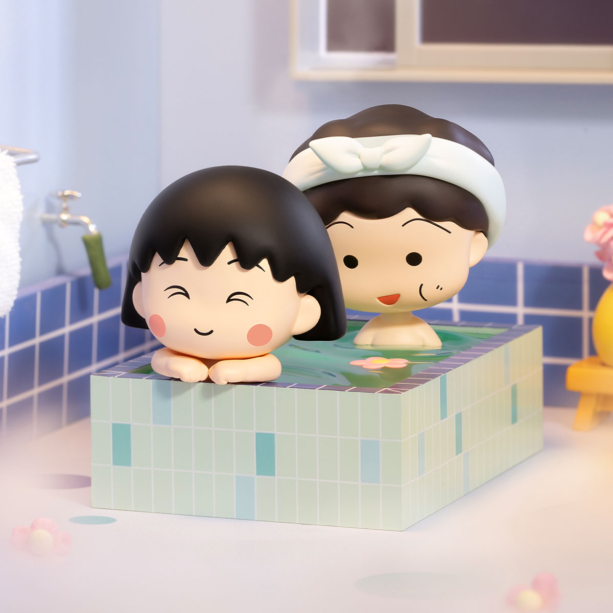 Chibi Maruko Chan's The Time With You Series Figures in a whimsical bath scene, showcasing two cartoon figures and a pink petal in mint-green tub.