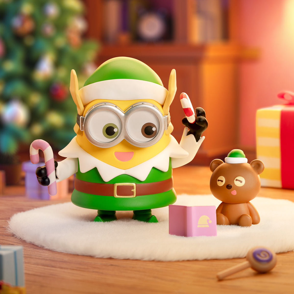 Minions Bedtime Stories figure in elf attire, holding candy canes, with teddy bear and gift box; part of a collectible series from Strangecat Toys.