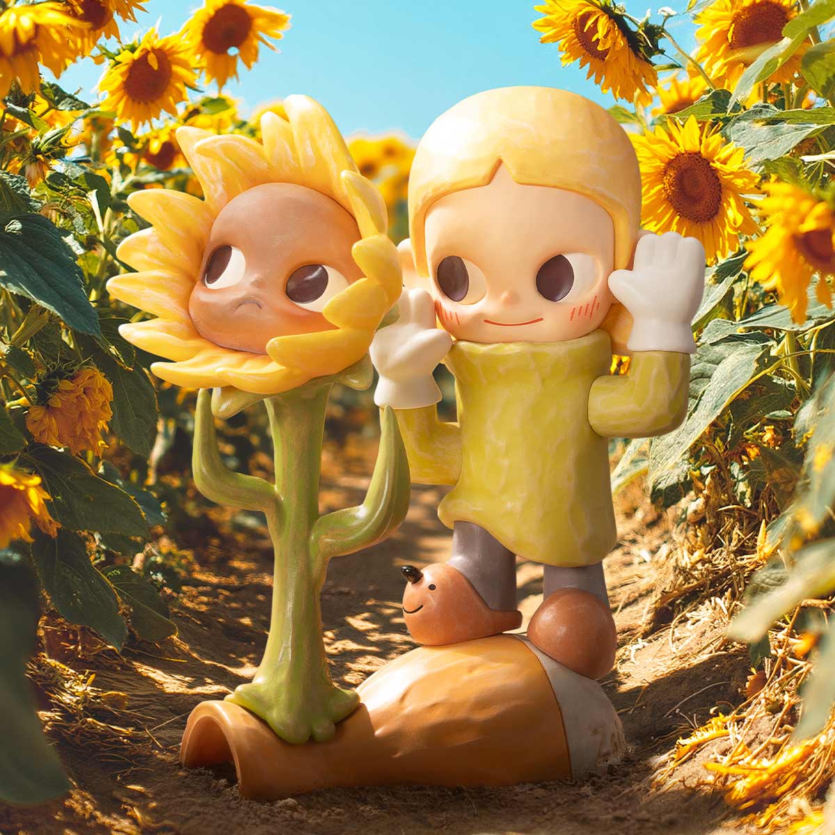 Zsiga Take It Slow Series Figures: sunflower-person and childlike character with snail toy, set in a sunflower field.