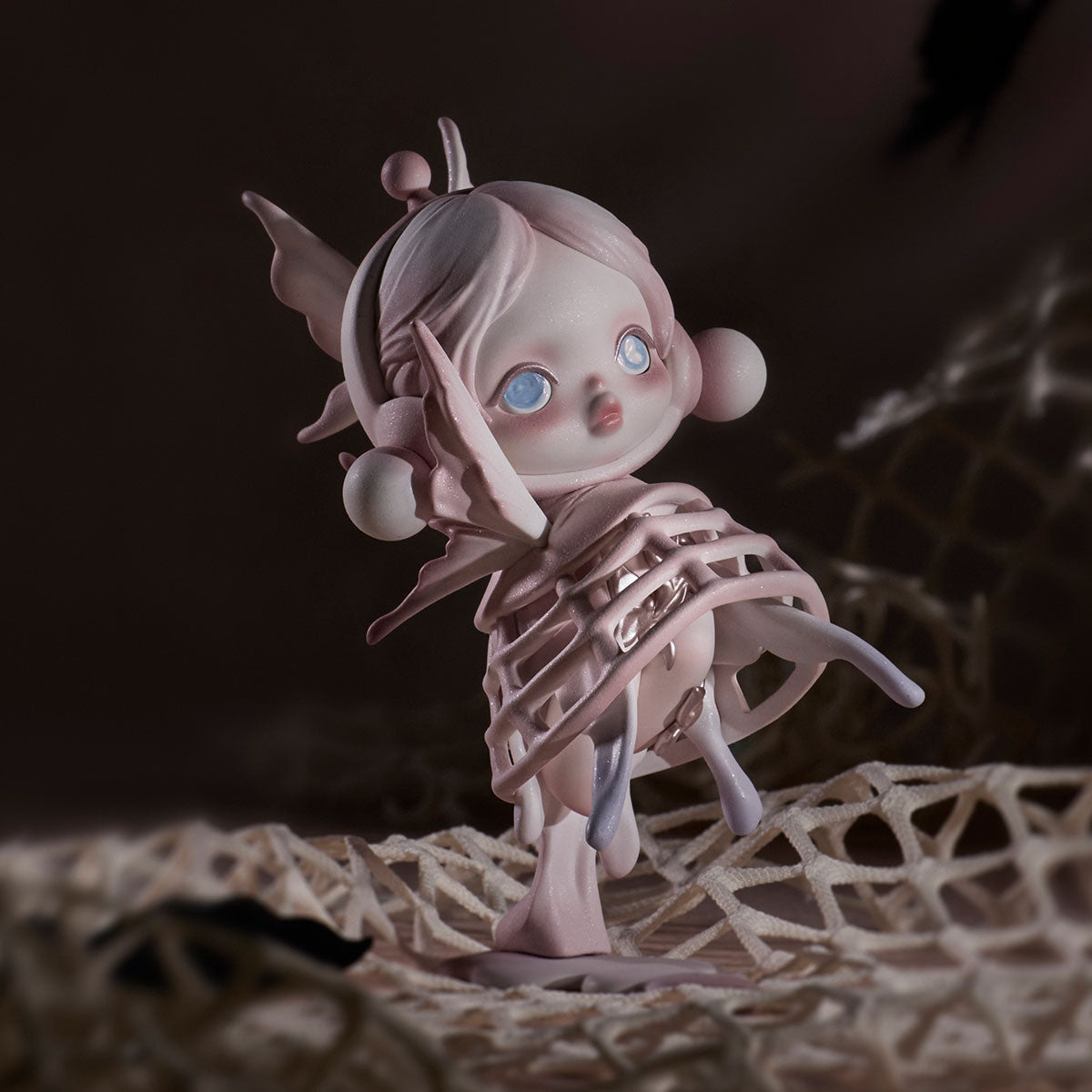 SKULLPANDA The Paradox Series Figure: pastel-pink, child-like character with oversized eyes, elf ears, and rib-cage tendrils, sculpted in resin or vinyl.