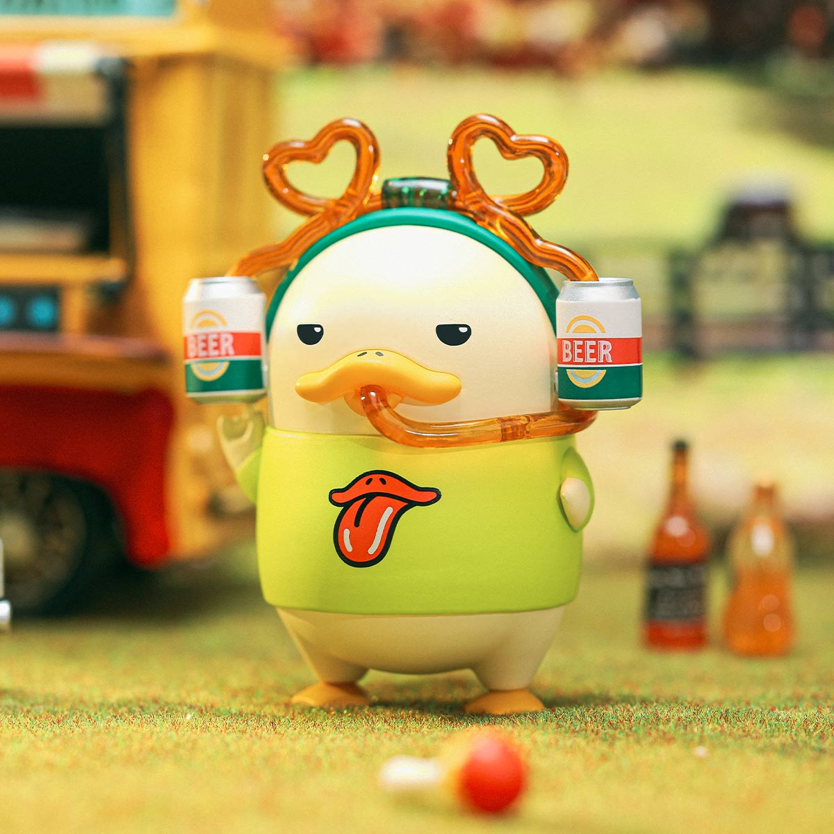 DUCKOO Music Festival Series toy figure with beer helmet, green shirt, on artificial grass. Preorder now for October 2025 shipment from Strangecat Toys.