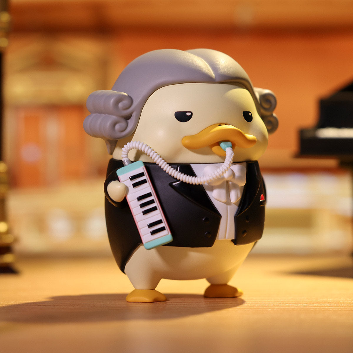 DUCKOO Music Festival Series figurine, a duck dressed as a classical musician holding a melodica, available for preorder, shipping end of Oct 2025.